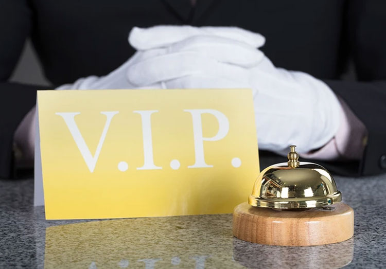 A bell and sign on top of a table.