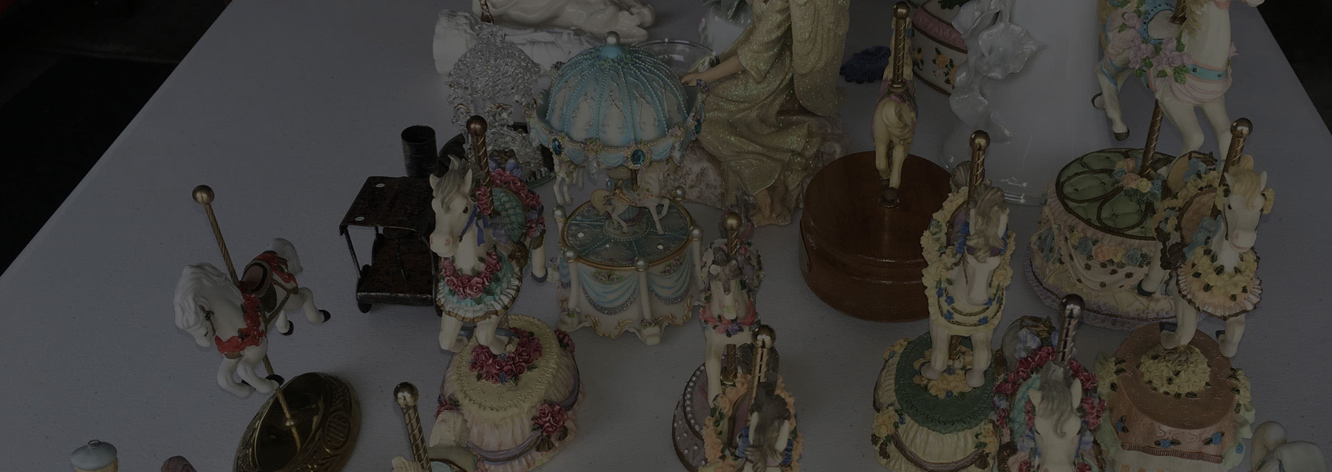 A table with many different figurines and ornaments.