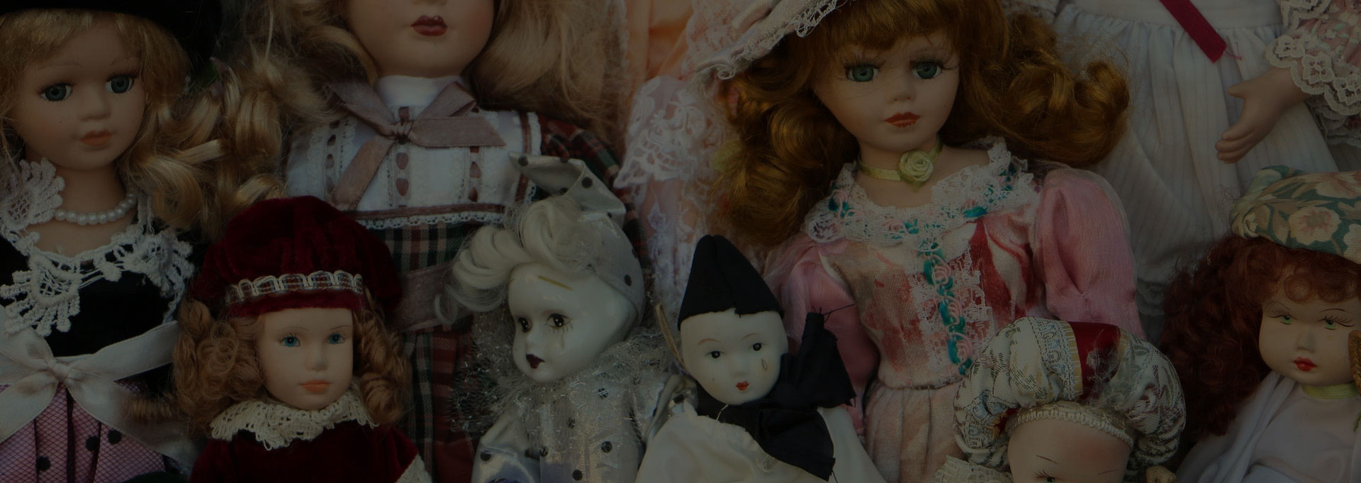 A group of dolls that are sitting on the ground.